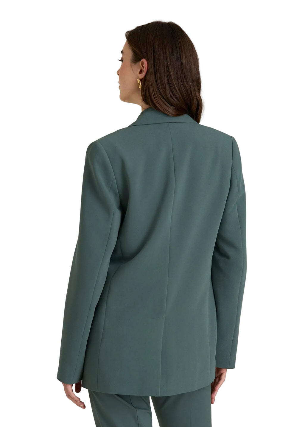 Person wearing a teal blazer and pants on a light gray background