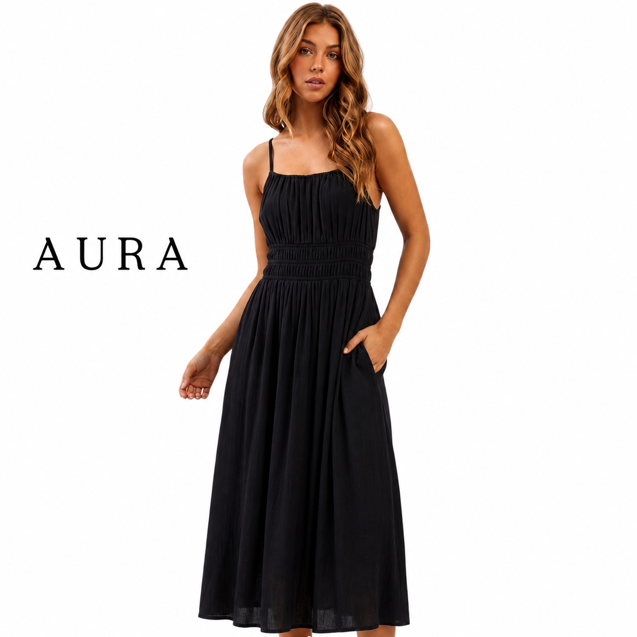 A woman modeling a black midi dress with spaghetti straps, a smocked bodice, and side pockets, shown against a plain white background with the brand name AURA on the left.