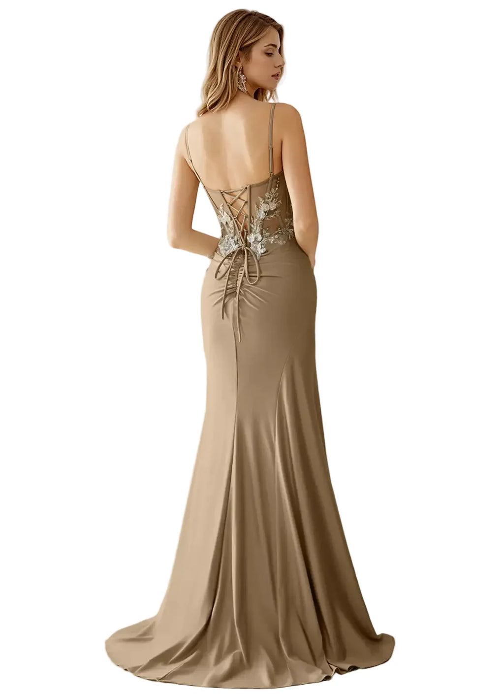 Woman wearing a beige evening gown with a backless design on a white background