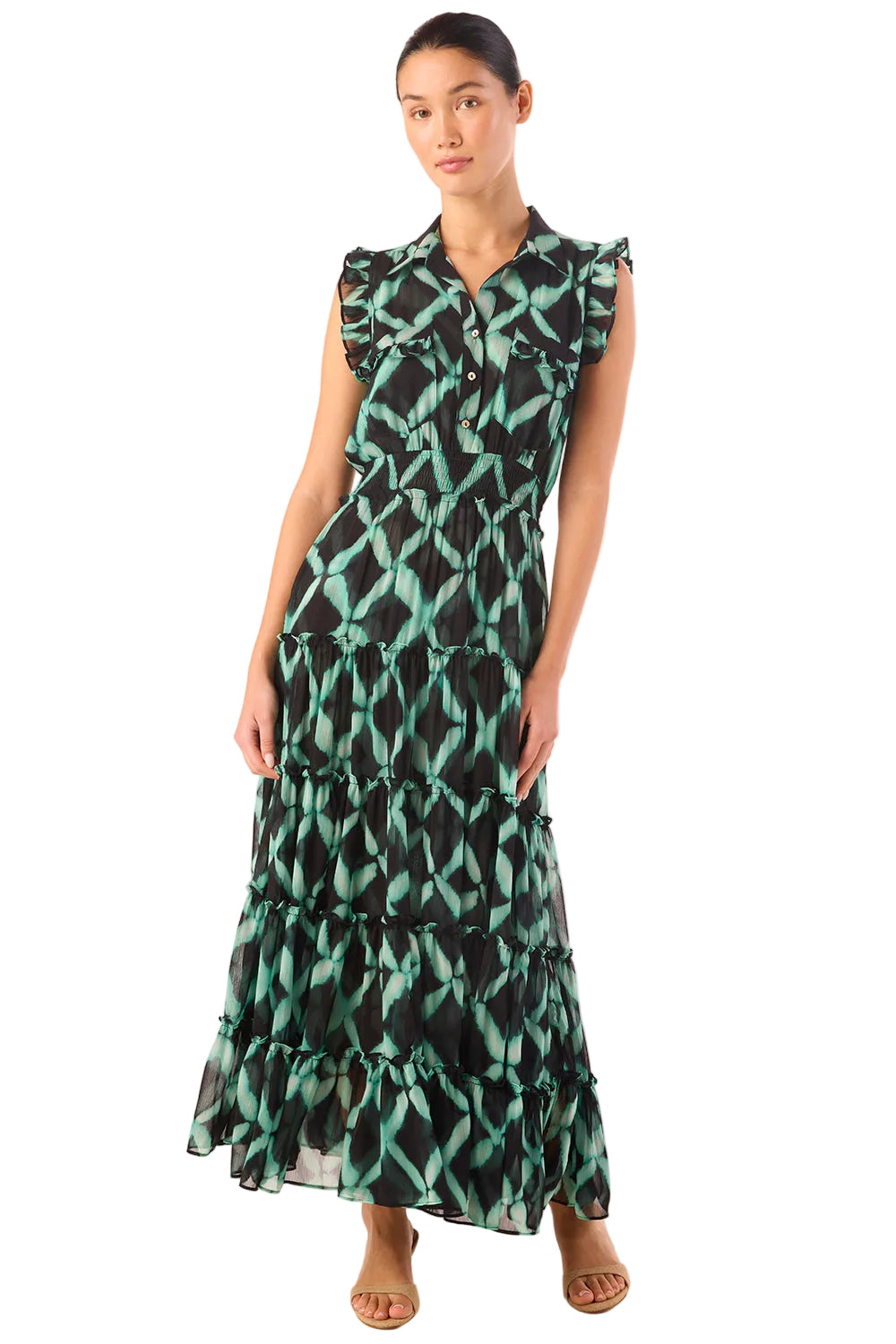 Woman wearing a green and black patterned dress on a white background
